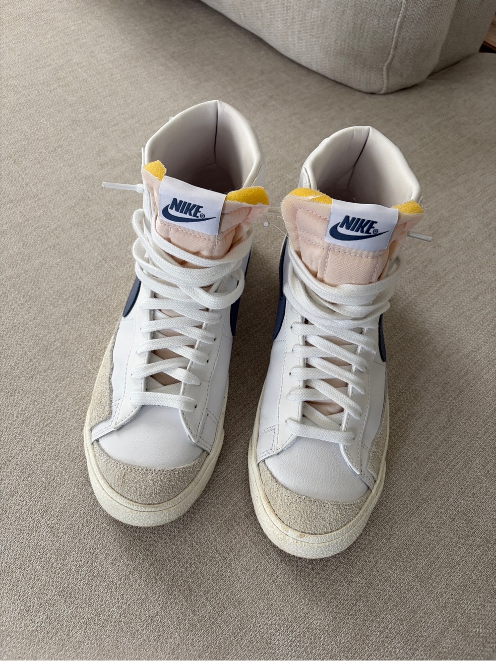 Nike White Leather Mid-Top Sneakers with Navy Swoosh and Yellow Tongue Tabs